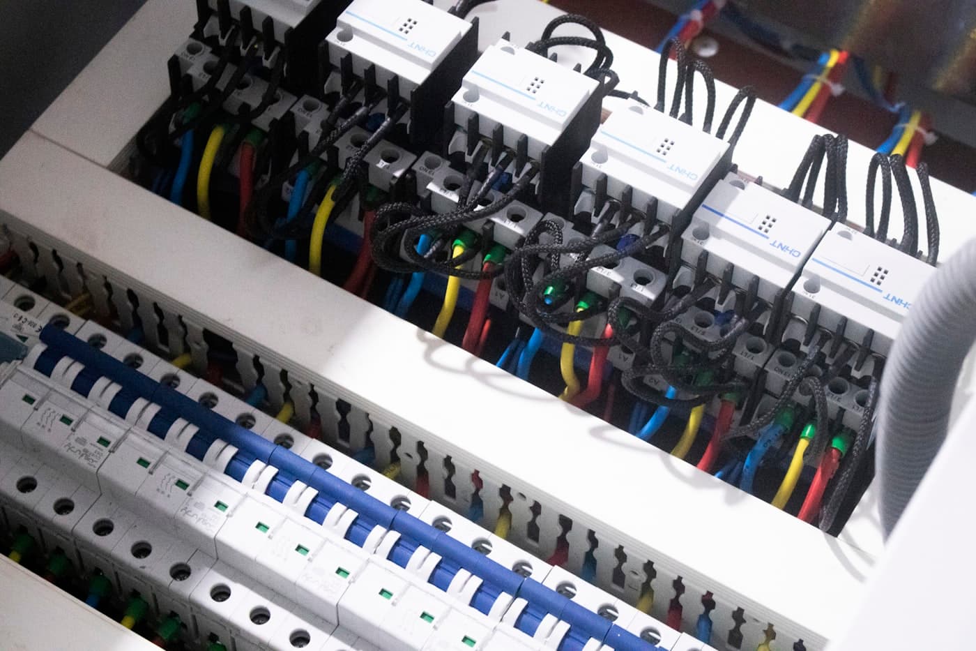An electrician working on an electrical panel