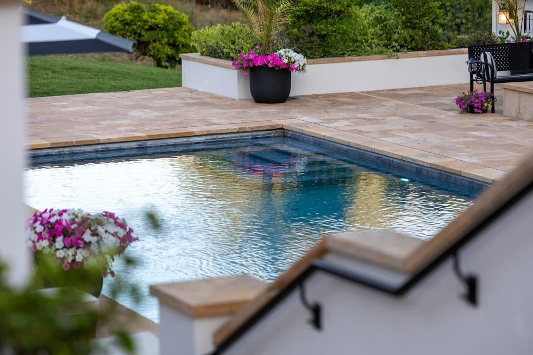 A paver pool deck with garden planters