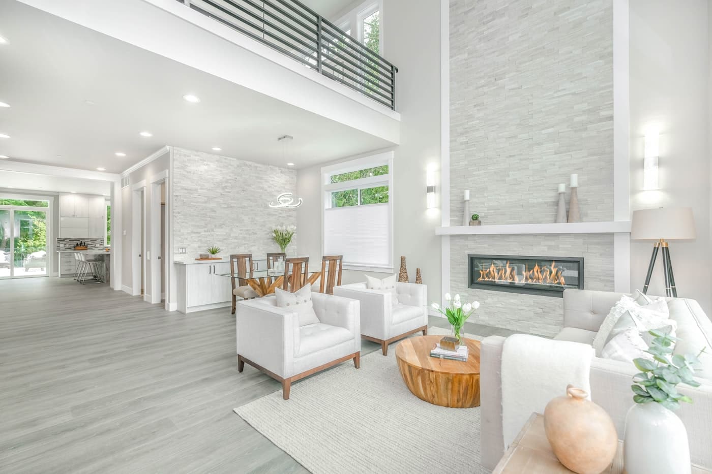 A bright, open living room with a stone fireplace