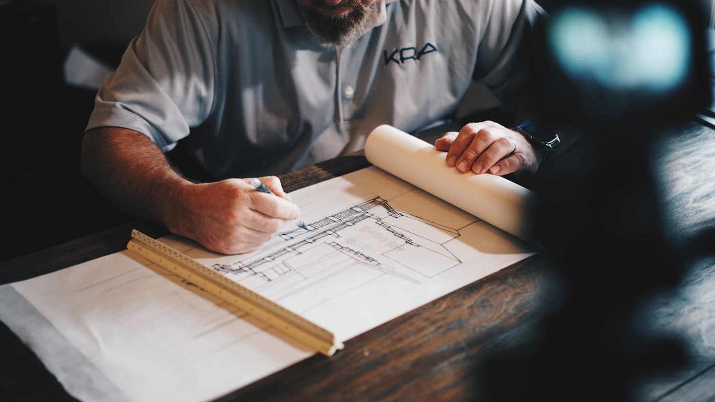 A contractor drawing up building plans